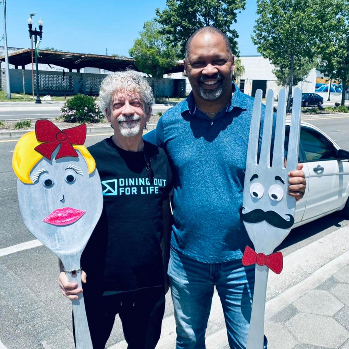 Two people holding a fork and spoon. Dining Out For Life® Jacksonville FL